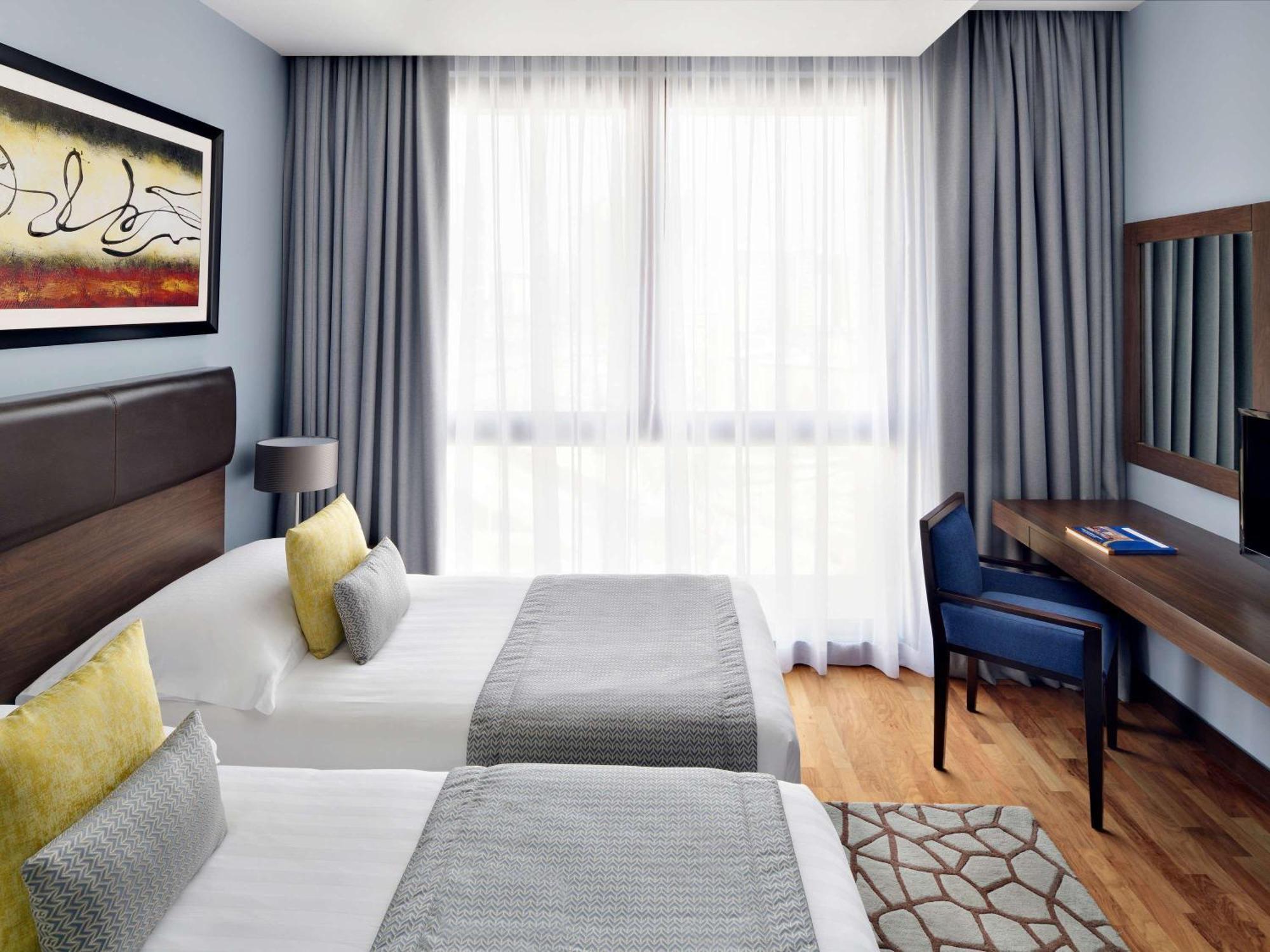 Moevenpick Hotel Apartments Al Mamzar Ντουμπάι Εξωτερικό φωτογραφία A room at the hotel
